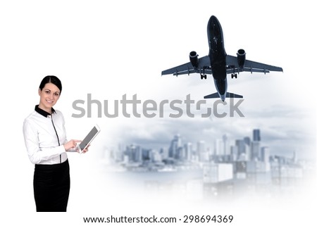 woman with a tablet and a plane over the city