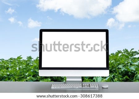 desktop computer on table, nature in the background