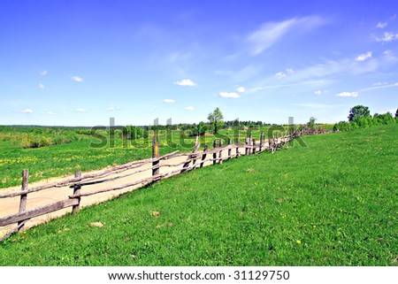 old fence on field along road