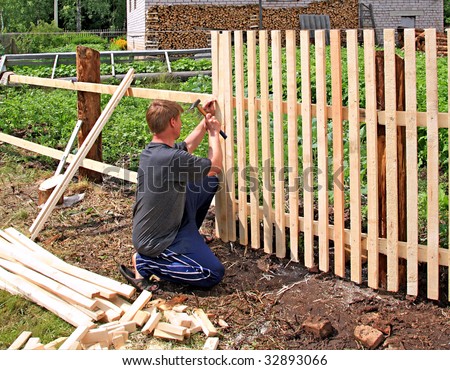 man builds fence