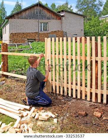 man builds new fence