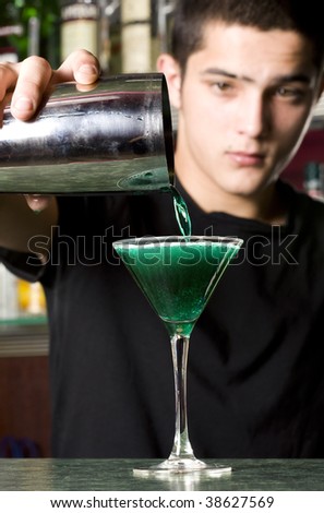 Barman with shaker making cocktail