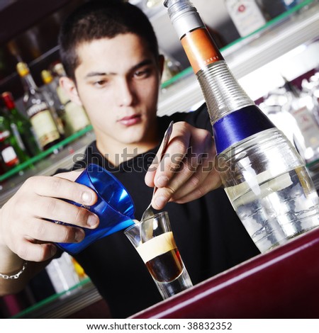 Young barman making cocktails