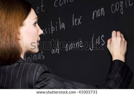 Young teacher writing legal proverbs in latin language