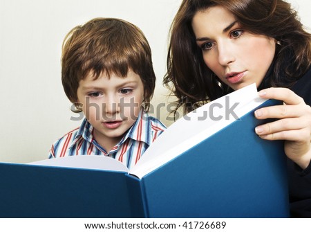 Mother reading to her son interesting story. Real emotions.