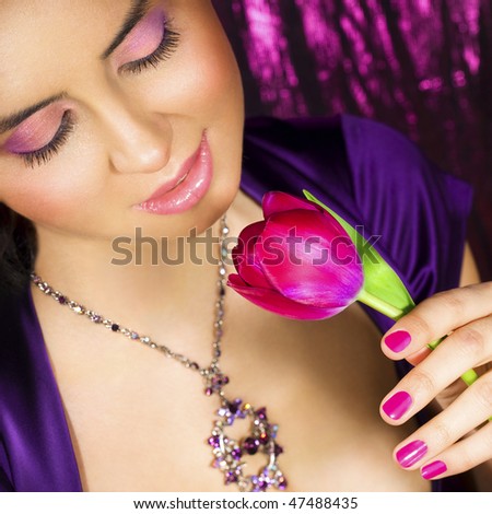 Woman with jewelry and pink flower