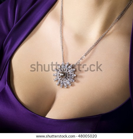 Woman in evening low-necked dress wearing luxury jewelry