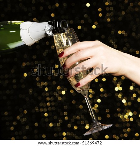 Woman hand with champagne glass on holiday background