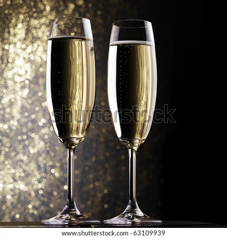 Champagne flutes on holiday background. Space for text.