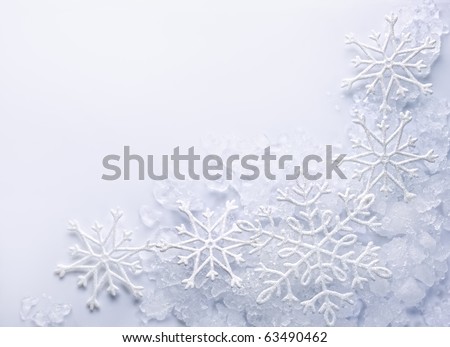 Snowflakes on snow background. Space for text.