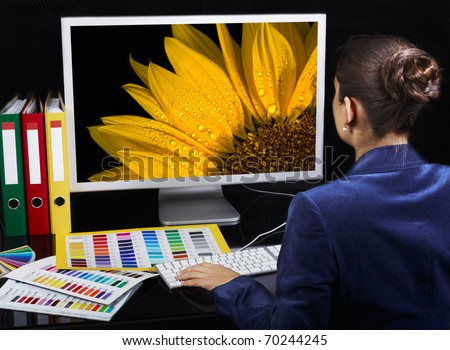 Designer at work. Vivid photo on computer monitor.