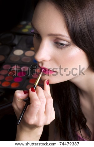 Makeup artist applying lipstick