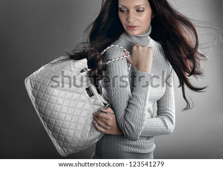 Stylish beautiful woman on grey background