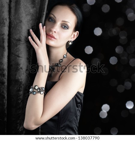 Beautiful Woman Behind The Curtain On Dark Sparkling Background