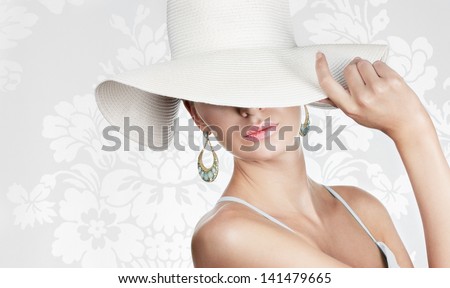 Elegant woman in white hat on white fancy background Space for text Elegant woman in white hat on white fancy background Space for text