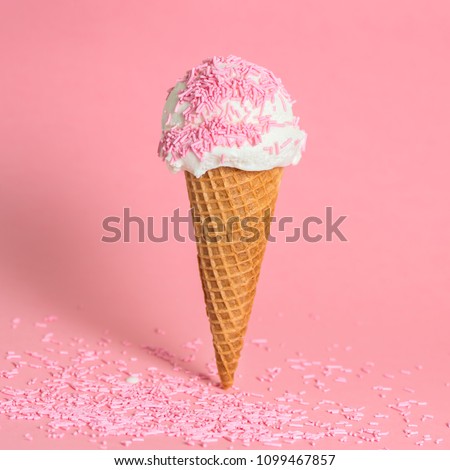funny creative concept of wafer cone with ice cream covered and strewed sprinkles on pink background, copy space