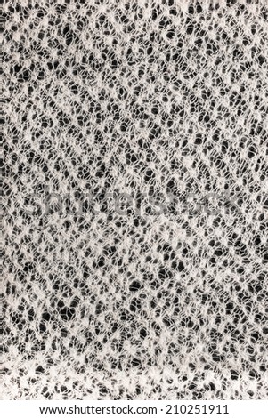 texture wool knitted cloth handmade on a black background, closeup