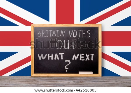 Brexit UK EU referendum final results concept for out of Great Britain from rest European union and handwriting text Britain votes out what next written in chalkboard on flag background