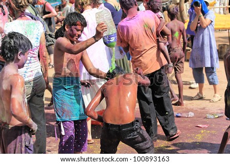 HAMPI, INDIA - MARCH 9: Unidentified people celebrate Holi festival in Hampi, India, March 9, 2012. It is a religious spring holiday and also known as Festival of Colours.