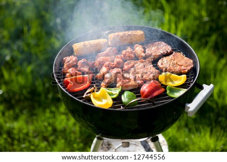 stock photo : Grilling at summer weekend. Fresh meat and vegetables preparing on grill.