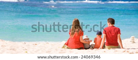 Family vacation. Young family of four in tropical paradise