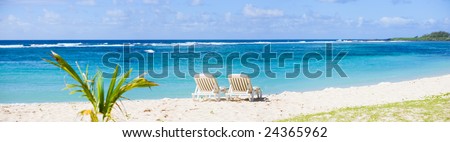 Tropical Paradise. Sun beds on tropical white sand beach.