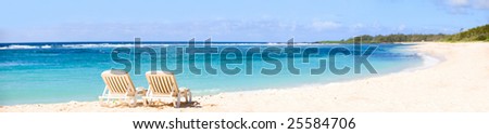 Tropical Paradise. Panorama of tropical white sand beach with sun beds.