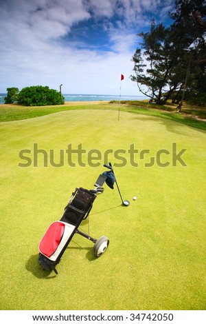Coastal Golf Course. Golf clubs in bag and ball on a beautiful golf course