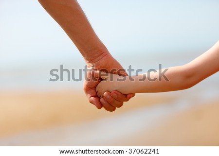 Close up of father and son hands