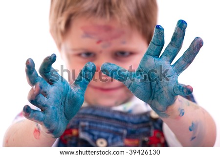 Funny photo of cute 5 years old boy painting on white background