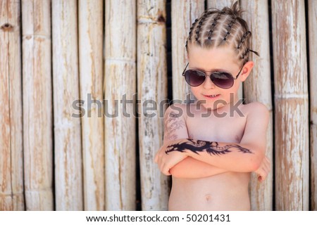 stock photo Cute 5 years old boy with african style hair and henna tattoo