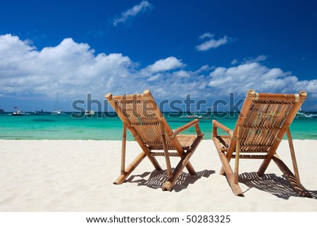 Two beach chairs on perfect tropical white sand beach in Boracay, Philippines