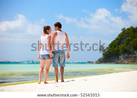 stock photo : Romantic couple walking on white sand beach