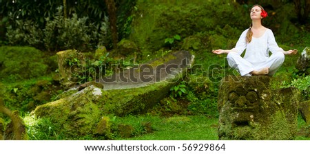 Young woman doing yoga outdoors in tranquil environment