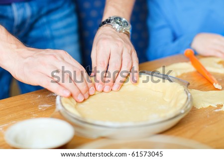 Closeup of man baking a pie
