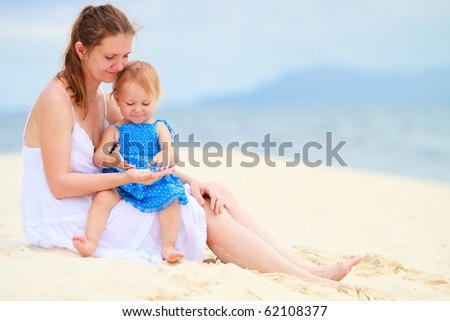 Young mother and her little toddler daughter on tropical vacation
