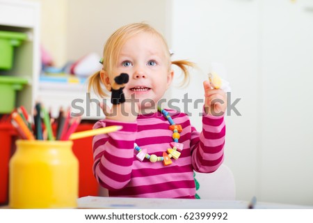 Adorable toddler girl playing with finger puppets