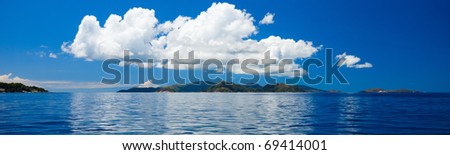 Panoramic photo of tropical islands at the middle of ocean in Seychelles and big cloud