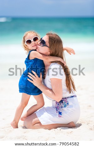 Young mother kissing her little daughter