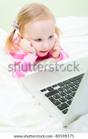 Wide lens shot of adorable little girl with laptop