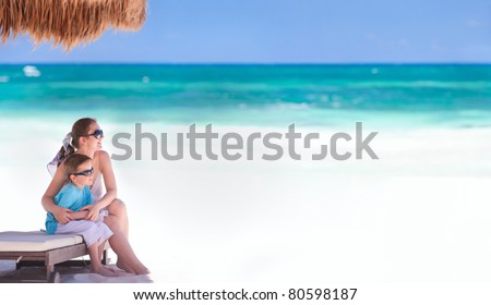 Panoramic photo of mother and son at tropical beach in Tulum Mexico