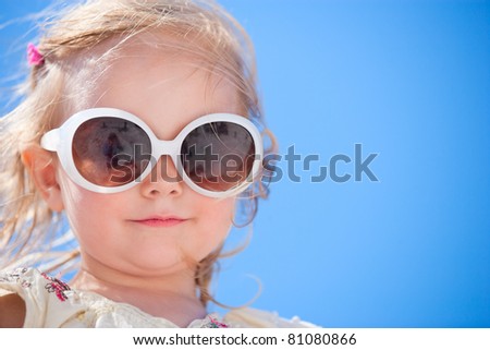 Portrait of adorable little girl in sun glasses