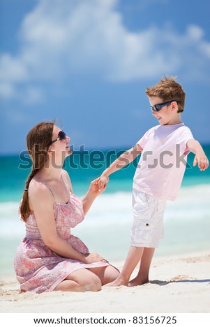 Happy mother and son at tropical beach