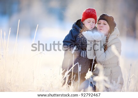 Mother and son enjoying beautiful winter day outdoors