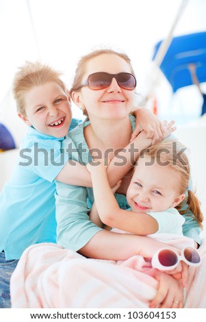 Beautiful mother and her kids having great time at luxury yacht