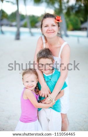 Portrait of happy relaxed family on a beach at the evening