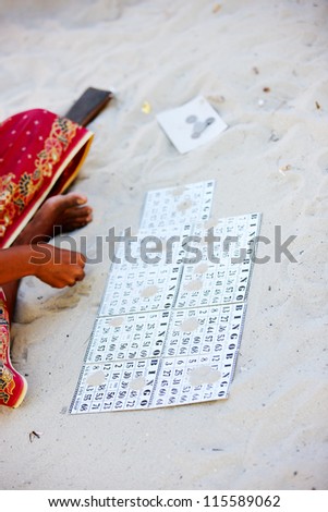 Close up of a woman playing bingo game in a sea gypsy village in Malaysia