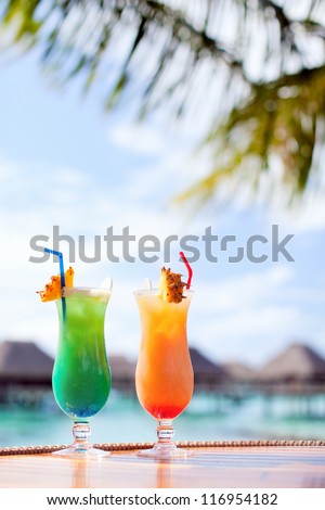 Two exotic cocktails in a tropical setting