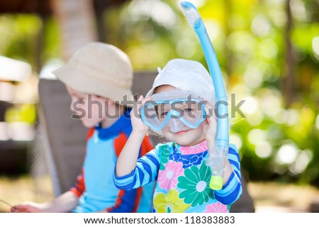 Cute playful girl wearing mask and snorkel
