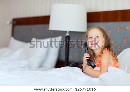 Adorable little girl talking on phone